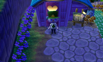 A line of purple violets next to Re-Tail in ACNL.