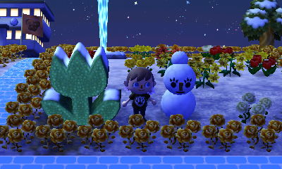 Jeff stands between a tulip topiary and a Snowmam.