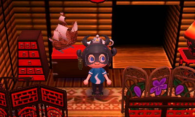 A sailboat model sits next to Wisp's lamp.