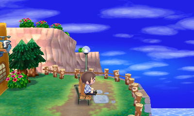Sitting on the bench at the end of Main Street in Animal Crossing: New Leaf.