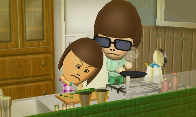 A young Kennedy cooking in the kitchen with her mother, Velma.